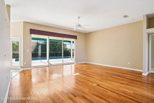 1526 Cypress Trace Dr, Melbourne, FL 32940 - empty room with wood finished floors, ceiling fan, and a textured ceiling