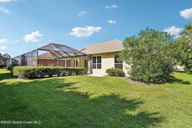 1526 Cypress Trace Dr, Melbourne, FL 32940 - back of house with a yard, stucco siding, and glass enclosure
