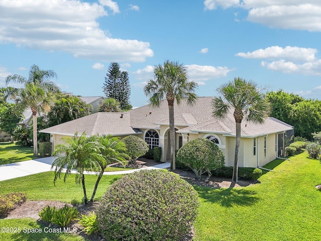 1526 Cypress Trace Dr, Melbourne, FL 32940 - mediterranean / spanish-style house with concrete driveway, stucco siding, a garage, and a front lawn