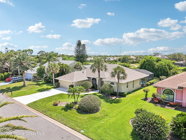 1526 Cypress Trace Dr, Melbourne, FL 32940 - view of front facade with driveway, a front yard, a garage, and a residential view