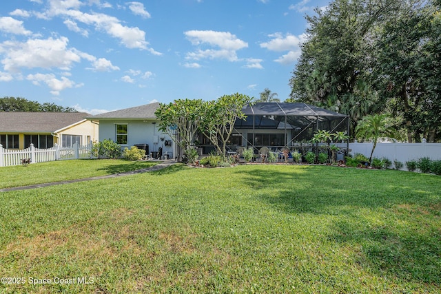 356 Fuller St SE, Palm Bay, FL 32909 - back of house featuring a fenced backyard, stucco siding, and glass enclosure