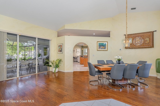 356 Fuller St SE, Palm Bay, FL 32909 - dining space featuring arched walkways, wood finished floors, and high vaulted ceiling