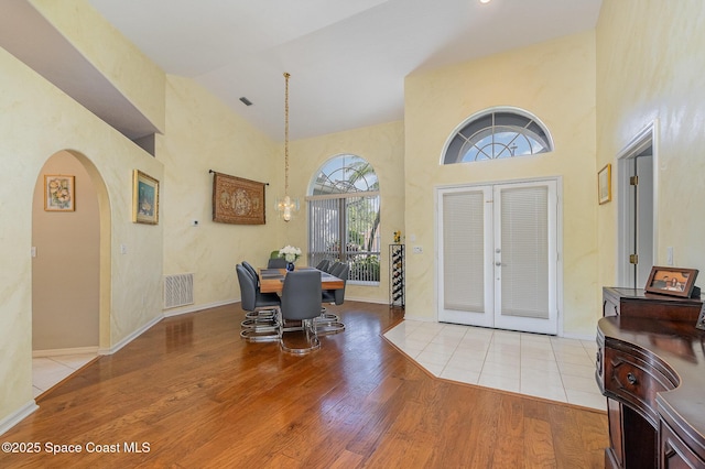 356 Fuller St SE, Palm Bay, FL 32909 - entrance foyer featuring arched walkways, a high ceiling, wood finished floors, and french doors