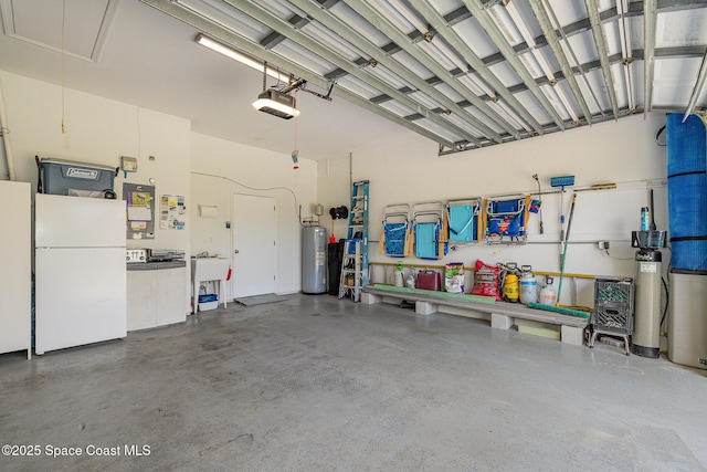 356 Fuller St SE, Palm Bay, FL 32909 - garage with freestanding refrigerator, water heater, and a garage door opener