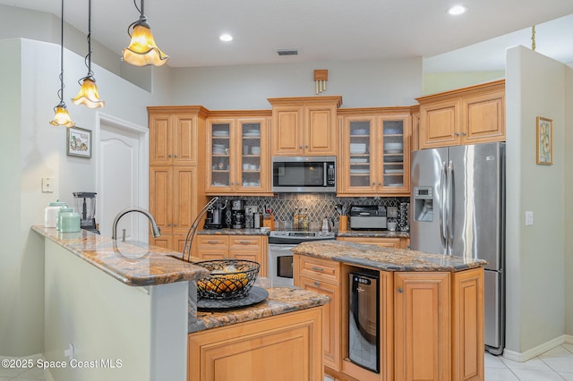 356 Fuller St SE, Palm Bay, FL 32909 - kitchen with appliances with stainless steel finishes, beverage cooler, decorative backsplash, stone counters, and a kitchen island