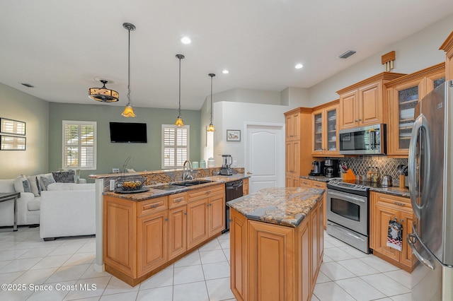 356 Fuller St SE, Palm Bay, FL 32909 - kitchen featuring stainless steel appliances, open floor plan, dark stone counters, tasteful backsplash, and glass insert cabinets