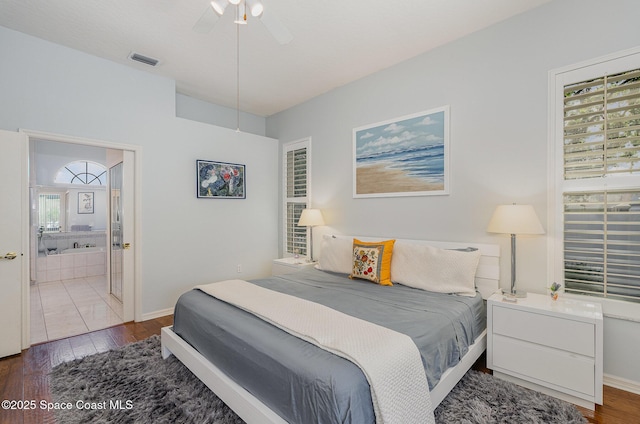 356 Fuller St SE, Palm Bay, FL 32909 - bedroom featuring wood finished floors, ensuite bath, and a ceiling fan