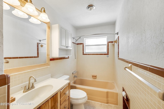 1575 Glen Haven Dr, Merritt Island, FL 32952 - bathroom featuring tile walls, vanity, washtub / shower combination, and tile patterned floors
