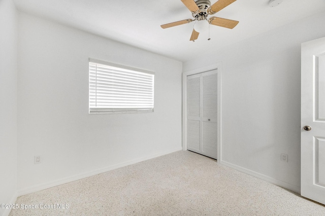 1575 Glen Haven Dr, Merritt Island, FL 32952 - unfurnished bedroom featuring speckle patterned floor, a closet, and ceiling fan
