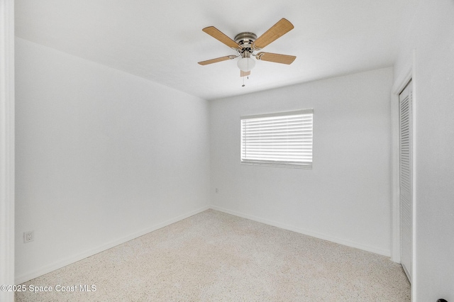 1575 Glen Haven Dr, Merritt Island, FL 32952 - unfurnished bedroom featuring speckle patterned floor, a closet, and ceiling fan
