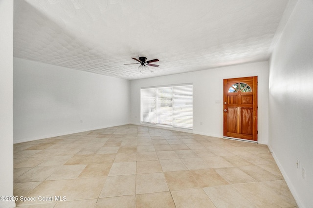 1575 Glen Haven Dr, Merritt Island, FL 32952 - empty room with a ceiling fan and light tile patterned flooring