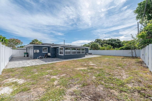 1575 Glen Haven Dr, Merritt Island, FL 32952 - back of property featuring a patio, a fenced backyard, and a gate