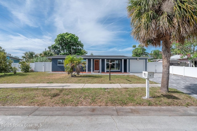 1575 Glen Haven Dr, Merritt Island, FL 32952 - view of front facade with an attached garage, driveway, and a gate