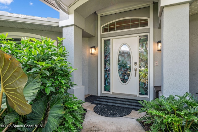 9495 Fleming Grant Rd, Sebastian, FL 32976 - view of exterior entry featuring stucco siding