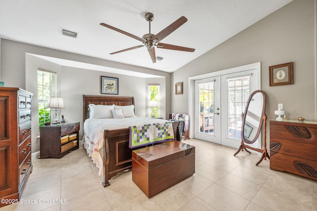 9495 Fleming Grant Rd, Sebastian, FL 32976 - bedroom with vaulted ceiling, french doors, access to exterior, light tile patterned floors, and a textured ceiling