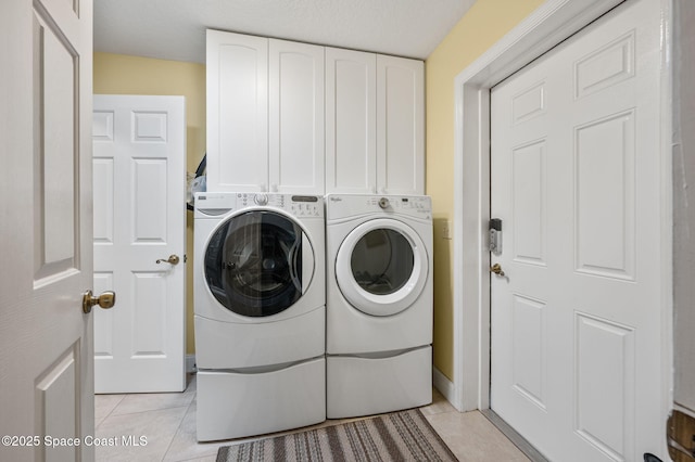 9495 Fleming Grant Rd, Sebastian, FL 32976 - laundry room with washing machine and dryer, cabinet space, and light tile patterned floors