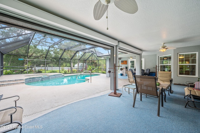 9495 Fleming Grant Rd, Sebastian, FL 32976 - view of swimming pool with ceiling fan, a patio, a pool with connected hot tub, and glass enclosure