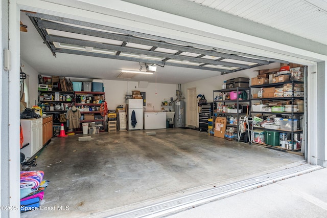 9495 Fleming Grant Rd, Sebastian, FL 32976 - garage featuring water heater, washing machine and clothes dryer, a garage door opener, and freestanding refrigerator