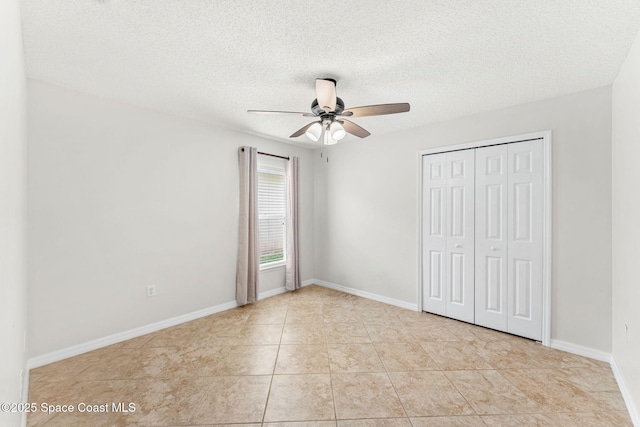 2341 Brookshire Cir, Melbourne, FL 32904 - unfurnished bedroom with a closet, a textured ceiling, ceiling fan, and tile patterned floors