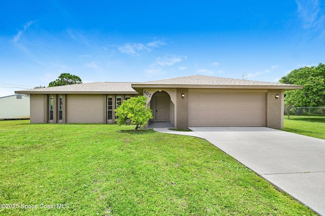407 Heather Ave NE, Palm Bay, FL 32907 - view of front facade with brick siding, driveway, a garage, and a front lawn