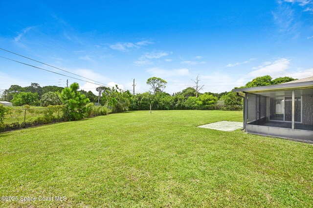 407 Heather Ave NE, Palm Bay, FL 32907 - view of yard featuring a sunroom and a patio area