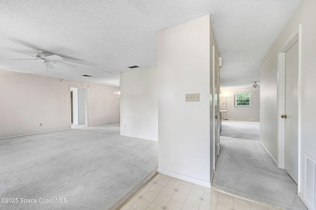 407 Heather Ave NE, Palm Bay, FL 32907 - spare room featuring light carpet, ceiling fan, a textured ceiling, and a chandelier