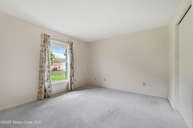 407 Heather Ave NE, Palm Bay, FL 32907 - spare room featuring carpet floors and a textured ceiling