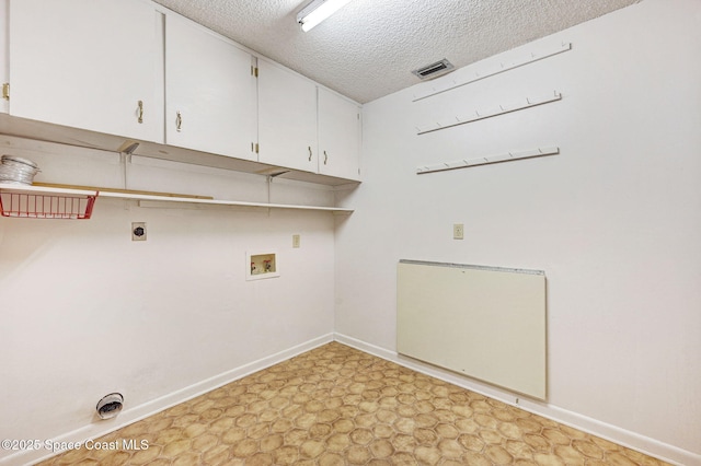 407 Heather Ave NE, Palm Bay, FL 32907 - washroom with cabinet space, electric dryer hookup, hookup for a washing machine, light floors, and a textured ceiling