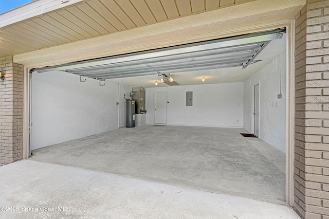 407 Heather Ave NE, Palm Bay, FL 32907 - garage featuring electric water heater, electric panel, and a garage door opener