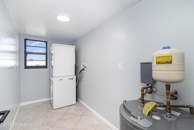 1145 N Shannon Ave Unit 29, Indialantic, FL 32903 - laundry room with estacked washer and dryer, water heater, and light tile patterned flooring