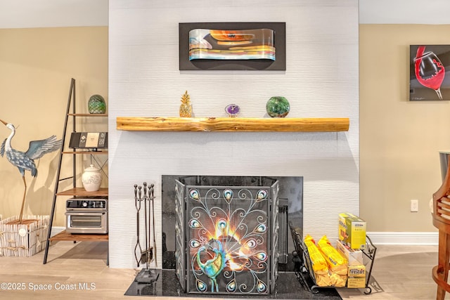 2220 Front St Unit 401, Melbourne, FL 32901 - detailed view of a warm lit fireplace and wood finished floors