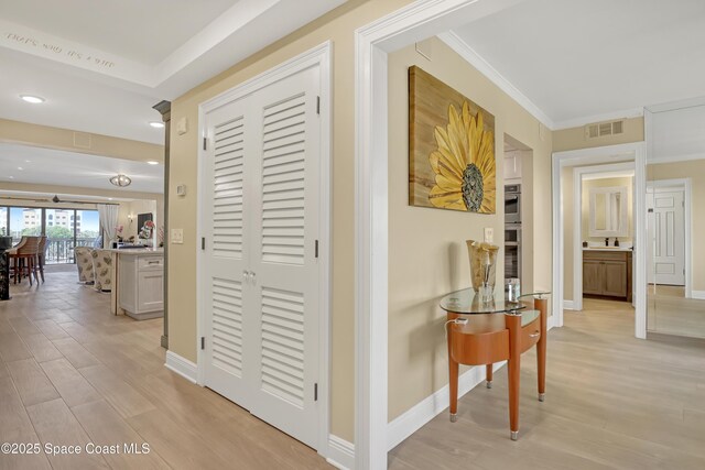 2220 Front St Unit 401, Melbourne, FL 32901 - hallway with light wood finished floors and ornamental molding