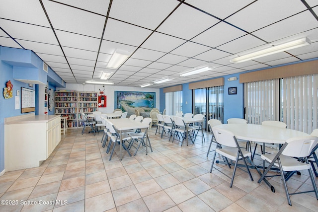 2467 S Washington Ave Unit 103B, Titusville, FL 32780 - dining room with light tile patterned floors and a paneled ceiling