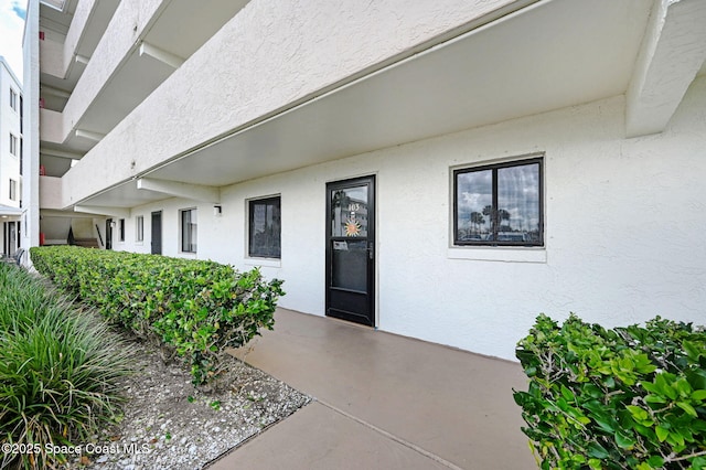 2467 S Washington Ave Unit 103B, Titusville, FL 32780 - entrance to property with stucco siding