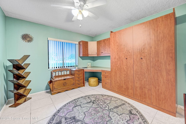2467 S Washington Ave Unit 103B, Titusville, FL 32780 - interior space featuring a textured ceiling, ceiling fan, a desk, and light tile patterned flooring