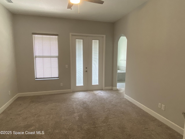 6684 Vista Hermosa Dr, Melbourne, FL 32940 - entrance foyer featuring ceiling fan, arched walkways, carpet, and french doors
