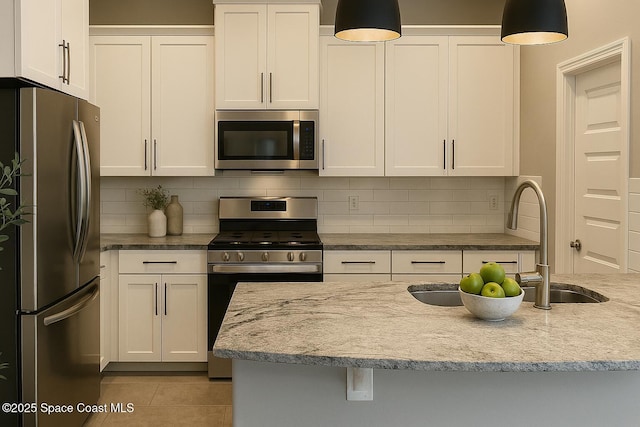 6684 Vista Hermosa Dr, Melbourne, FL 32940 - kitchen featuring stainless steel appliances, tasteful backsplash, and white cabinets