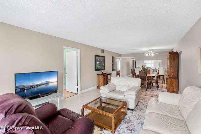 840 N Atlantic Ave Unit C103, Cocoa Beach, FL 32931 - living area featuring a textured ceiling, a ceiling fan, and light tile patterned floors