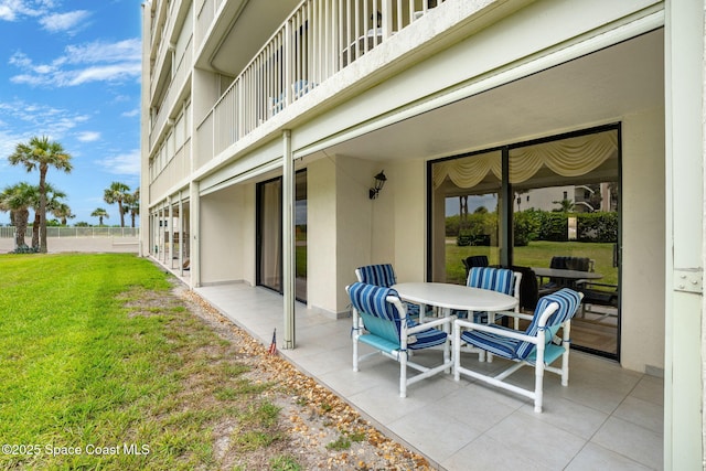 840 N Atlantic Ave Unit C103, Cocoa Beach, FL 32931 - patio / terrace featuring a patio, a yard, and outdoor dining space