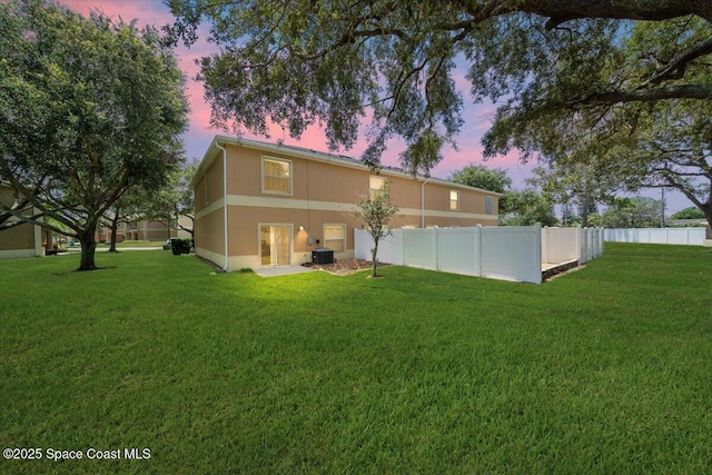 2605 Revolution St Unit 104, Melbourne, FL 32935 - back of property at dusk with stucco siding