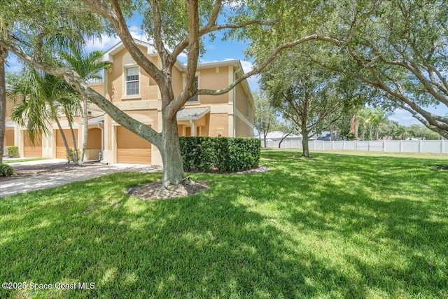 2605 Revolution St Unit 104, Melbourne, FL 32935 - view of front of property with an attached garage, stucco siding, and driveway