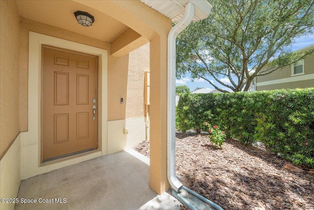 2605 Revolution St Unit 104, Melbourne, FL 32935 - doorway to property featuring stucco siding