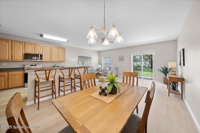 2605 Revolution St Unit 104, Melbourne, FL 32935 - dining area with light wood finished floors and a chandelier