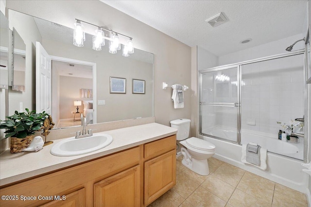 2605 Revolution St Unit 104, Melbourne, FL 32935 - bathroom with vanity, tile patterned flooring, bath / shower combo with glass door, and a textured ceiling
