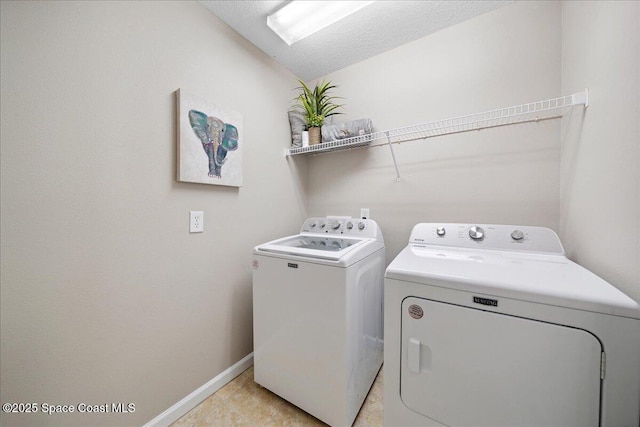 2605 Revolution St Unit 104, Melbourne, FL 32935 - laundry room with washing machine and clothes dryer and light tile patterned flooring