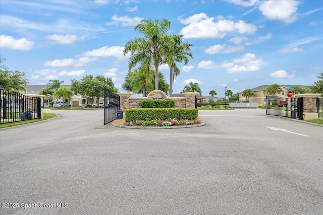 2605 Revolution St Unit 104, Melbourne, FL 32935 - community sign featuring a gate, a residential view, and uncovered parking