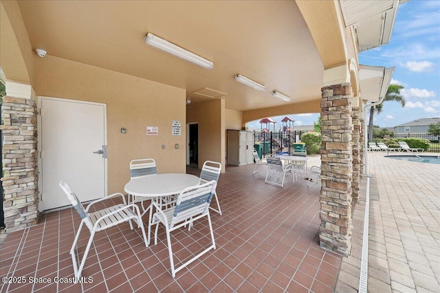 2605 Revolution St Unit 104, Melbourne, FL 32935 - view of patio featuring outdoor dining area and a community pool