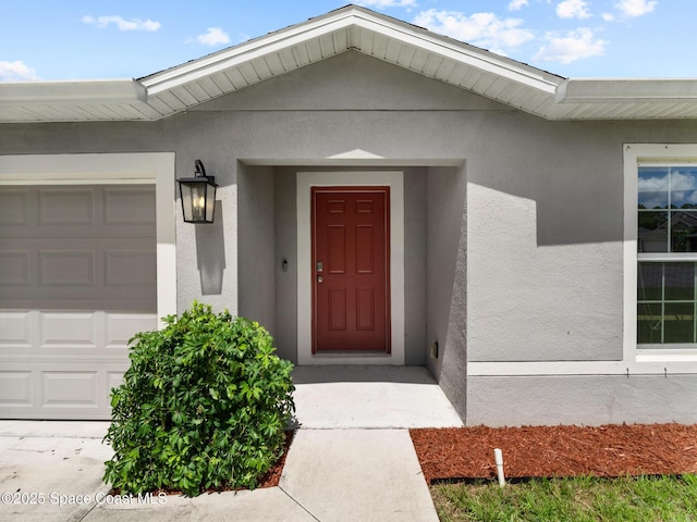 2926 Tishman Rd SE, Palm Bay, FL 32909 - property entrance with an attached garage and stucco siding