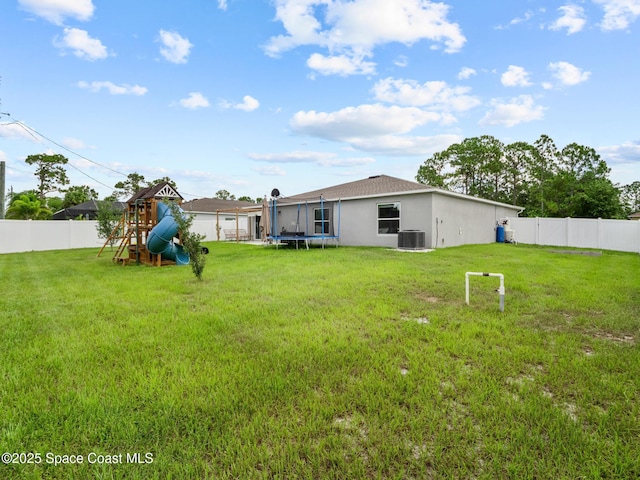 2926 Tishman Rd SE, Palm Bay, FL 32909 - fenced backyard featuring a trampoline and a playground