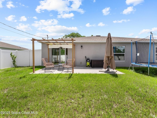 2926 Tishman Rd SE, Palm Bay, FL 32909 - back of property featuring a trampoline, stucco siding, a pergola, and a patio